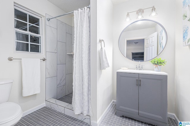 bathroom with tile patterned floors, vanity, toilet, and walk in shower