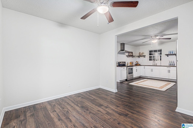 interior space featuring a textured ceiling, ceiling fan, sink, and dark wood-type flooring