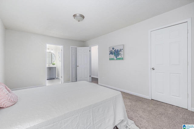 carpeted bedroom with ensuite bathroom