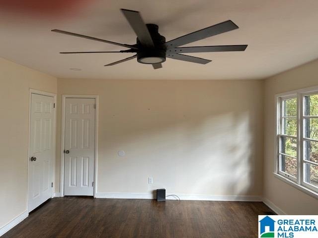 unfurnished room featuring ceiling fan and dark hardwood / wood-style flooring