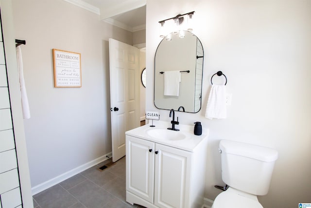 bathroom with tile patterned floors, toilet, vanity, and ornamental molding