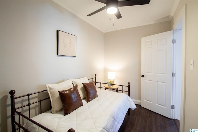 bedroom with ceiling fan, crown molding, and dark wood-type flooring