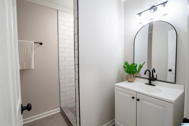 bathroom with tile patterned flooring, vanity, and a tile shower