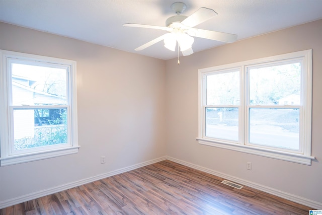 unfurnished room with ceiling fan and hardwood / wood-style flooring