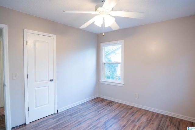 empty room with hardwood / wood-style floors and ceiling fan