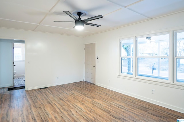 spare room with ceiling fan, plenty of natural light, and hardwood / wood-style floors