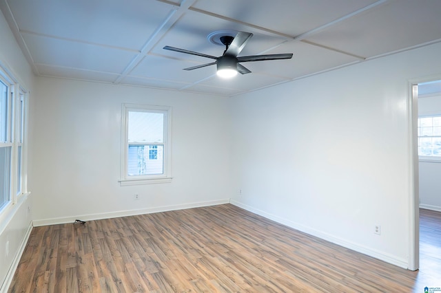 spare room with ceiling fan, hardwood / wood-style floors, and coffered ceiling