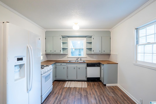 kitchen featuring white appliances, wooden counters, sink, dark hardwood / wood-style floors, and ornamental molding