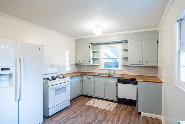 kitchen with wooden counters, dark hardwood / wood-style flooring, white appliances, and sink