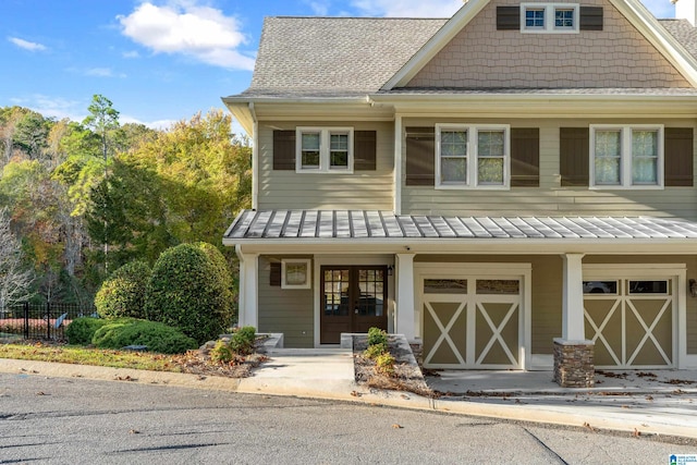 craftsman-style home featuring french doors and a garage