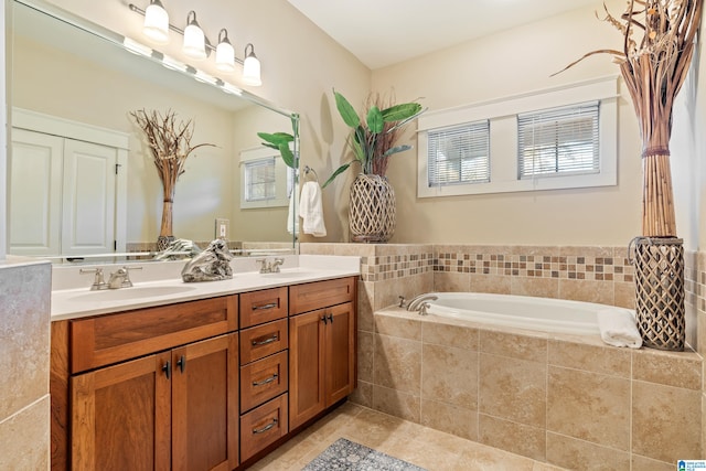 bathroom featuring tiled bath, tile patterned flooring, and vanity