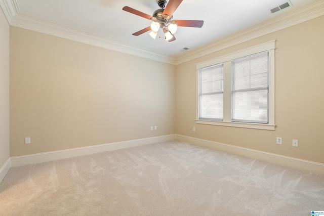 spare room featuring ceiling fan, ornamental molding, and light carpet