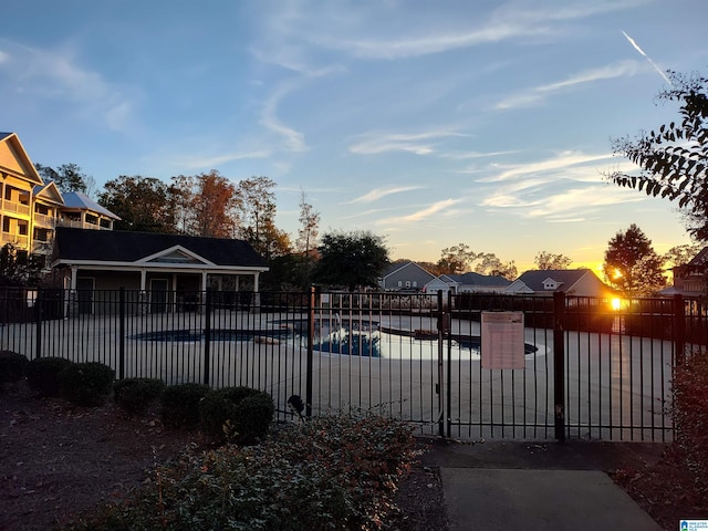 view of pool at dusk