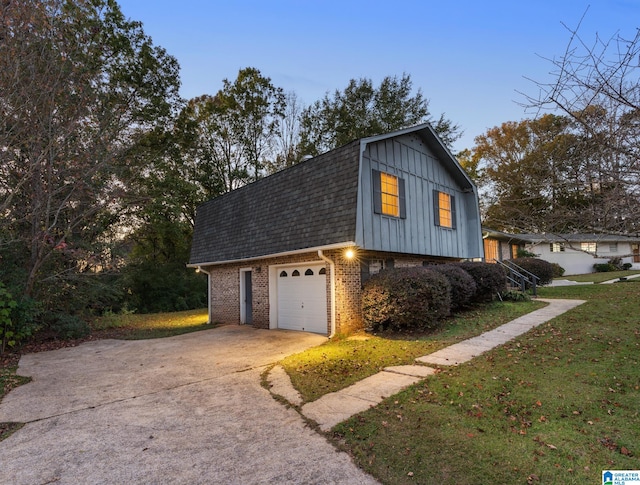 view of property exterior featuring a garage and a lawn