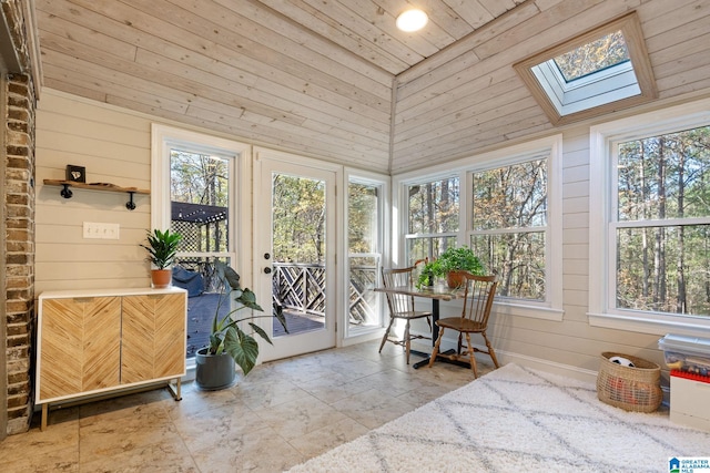 sunroom / solarium with wood ceiling, lofted ceiling with skylight, and a healthy amount of sunlight