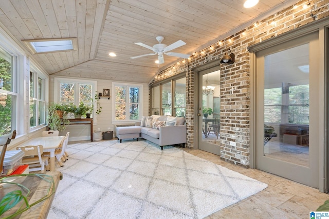 sunroom with lofted ceiling with skylight, wooden ceiling, and ceiling fan with notable chandelier