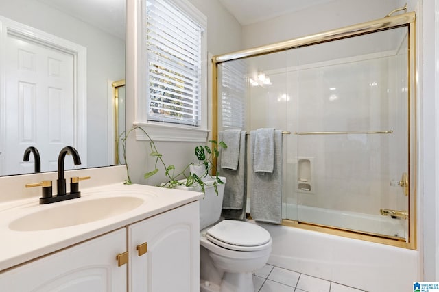 full bathroom with shower / bath combination with glass door, tile patterned flooring, vanity, and toilet