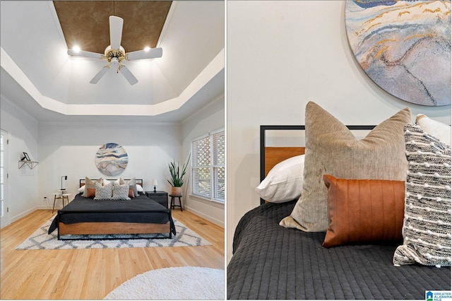 bedroom with hardwood / wood-style flooring, ceiling fan, ornamental molding, and a tray ceiling