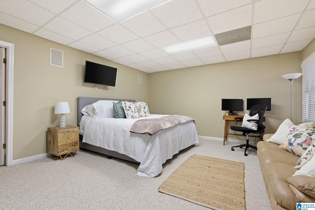 bedroom with a drop ceiling and carpet floors