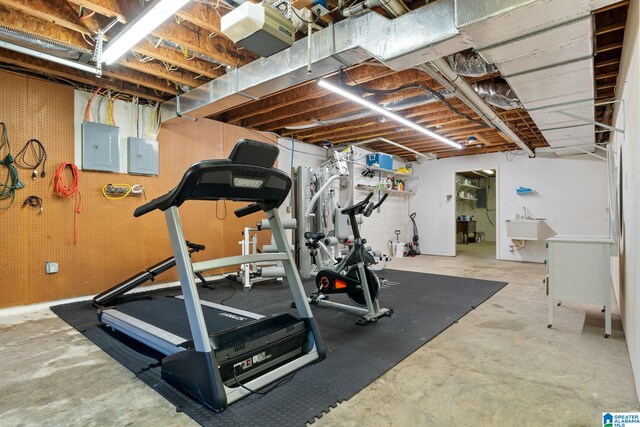 exercise room featuring sink and electric panel