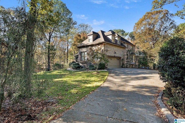 view of front of house featuring a garage and a front lawn