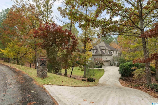 exterior space with a garage and a front lawn