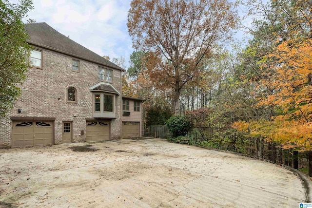 view of side of home featuring a garage