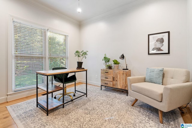 office area with light hardwood / wood-style floors and crown molding