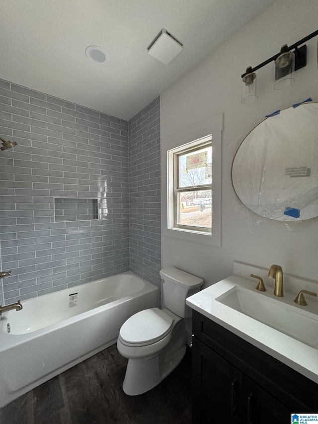 full bathroom with hardwood / wood-style flooring, vanity, toilet, and tiled shower / bath combo