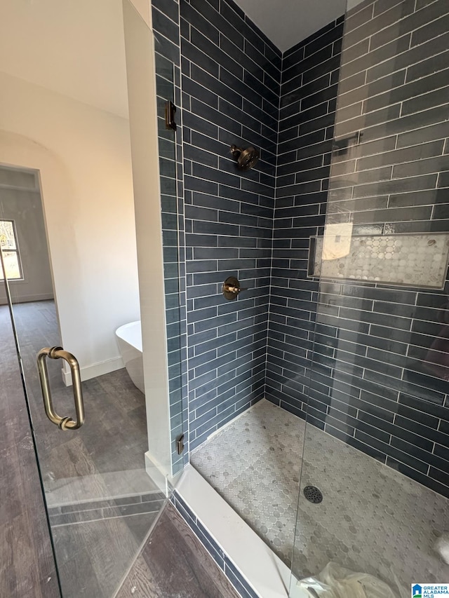 bathroom featuring shower with separate bathtub