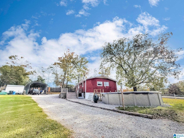 view of property exterior with a carport and a lawn