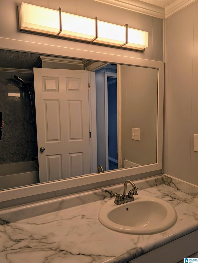 bathroom with vanity and ornamental molding