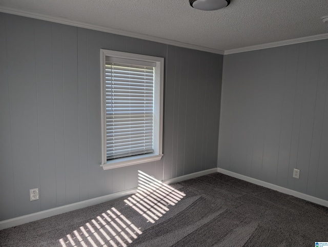 carpeted empty room with a textured ceiling and crown molding