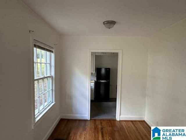 spare room featuring dark hardwood / wood-style flooring