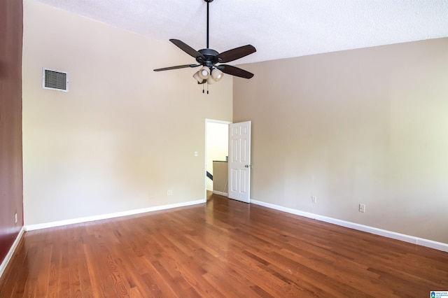 spare room with ceiling fan, dark hardwood / wood-style flooring, high vaulted ceiling, and a textured ceiling