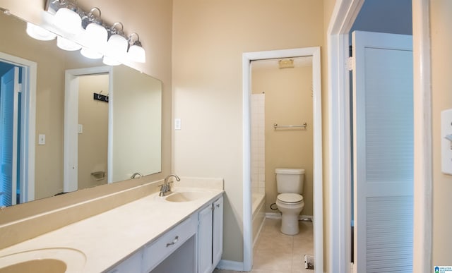 bathroom with tile patterned flooring, vanity, and toilet