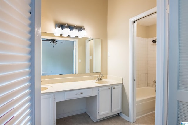 bathroom with tile patterned floors, ceiling fan, vanity, and tiled shower / bath combo