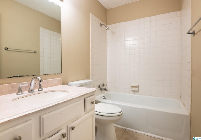 full bathroom with tile patterned floors, vanity, a textured ceiling, tiled shower / bath combo, and toilet