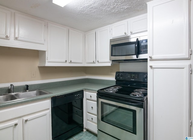 kitchen featuring white cabinets, sink, stainless steel appliances, and a textured ceiling