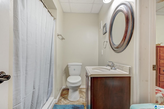 bathroom featuring a shower with shower curtain, a paneled ceiling, vanity, tile patterned flooring, and toilet