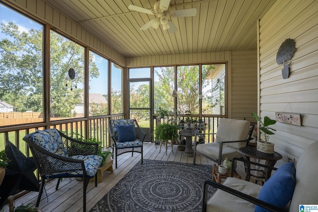 sunroom / solarium featuring ceiling fan