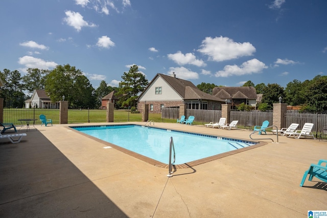 view of swimming pool with a yard and a patio area