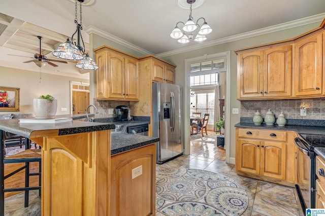 kitchen with appliances with stainless steel finishes, tasteful backsplash, decorative light fixtures, and a kitchen breakfast bar