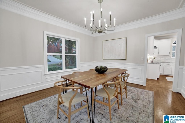 dining room featuring a notable chandelier, dark hardwood / wood-style floors, and ornamental molding