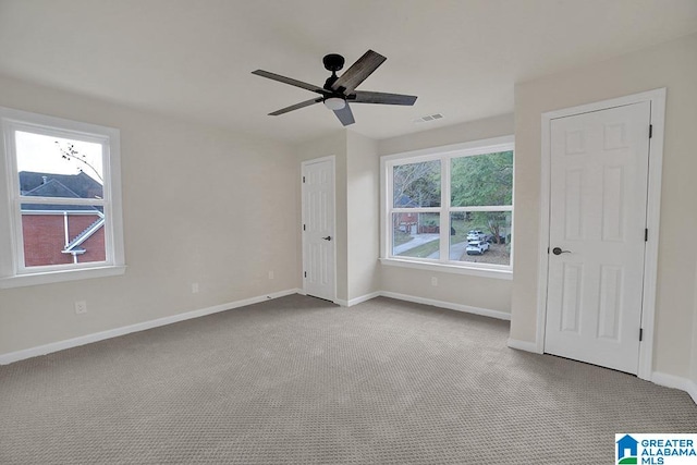 unfurnished bedroom featuring light colored carpet and ceiling fan