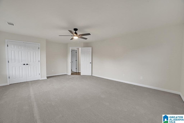 unfurnished bedroom with ceiling fan and carpet floors