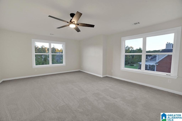 carpeted spare room with ceiling fan