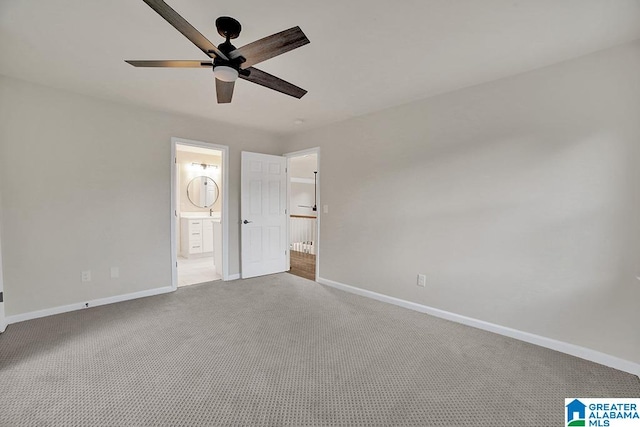 unfurnished bedroom with carpet, ensuite bath, and ceiling fan