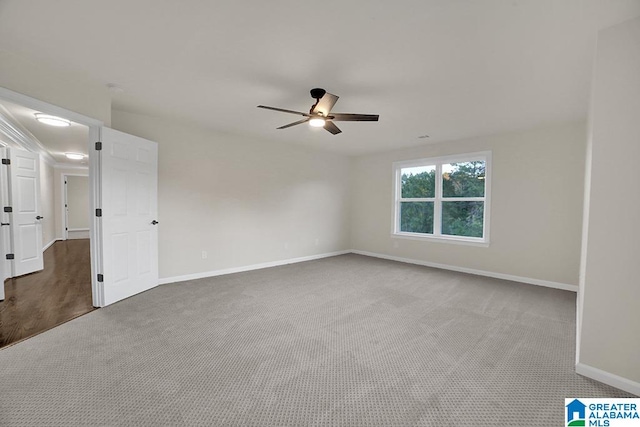 spare room with carpet floors and ceiling fan