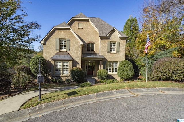 2399 Huntington Glen Dr, Homewood, AL 35226 - view of front of home with a standing seam roof, stucco siding, roof with shingles, and metal roof
